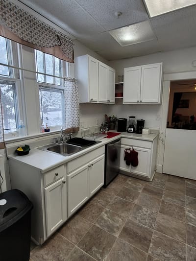 Interior view of a kitchen with white cabinets