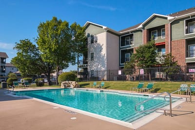 Swimming pool area surrounded by greenery