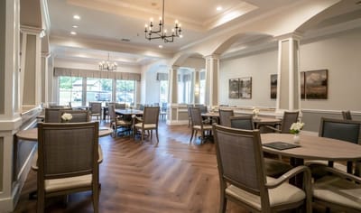 Bright dining room with tables and chairs set for meals