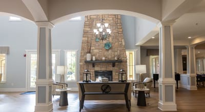 Bright and inviting common area with a stone fireplace
