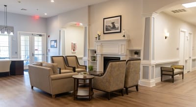 Common area with seating and fireplace in the facility