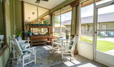 Sunlit common area with seating and greenery