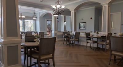 Brightly lit dining area with tables and chairs