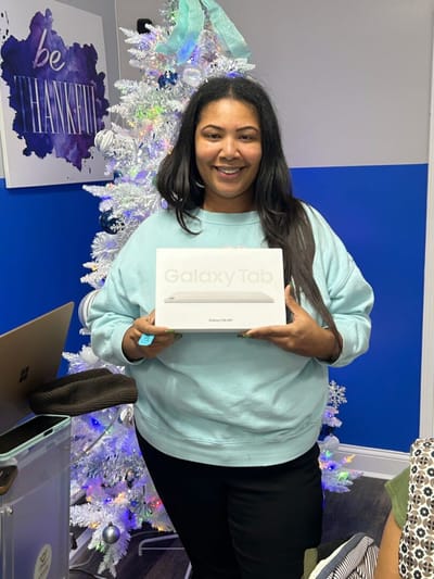 Woman holding a Galaxy Tab in a decorated room