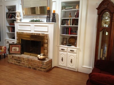 Cozy common area with a fireplace and bookshelves.