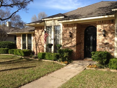 Facade of a residential building with landscaping.