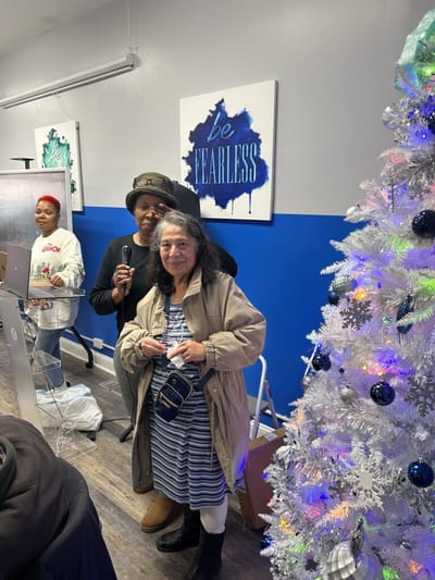 Residents and staff celebrating in a decorated indoor space.