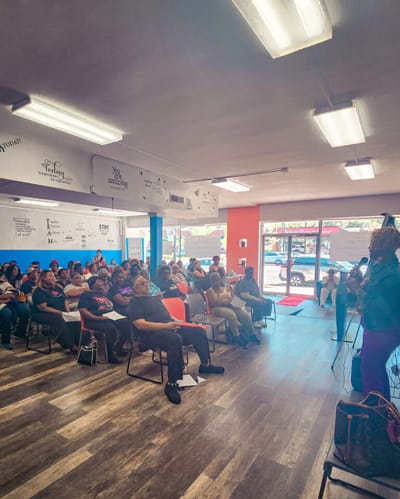Gathering of individuals in a community meeting space.