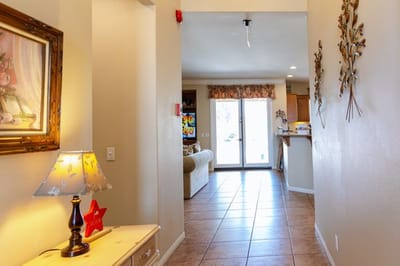 Hallway leading to the common area with light fixtures.