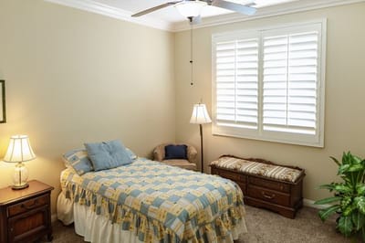 Cozy resident room with a bed and chair.
