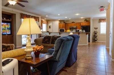 Cozy common area with couches and kitchen view.