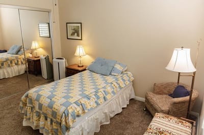 Cozy bedroom setup with single bed and furnishings.