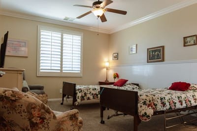 A shared resident room with two beds and decor.