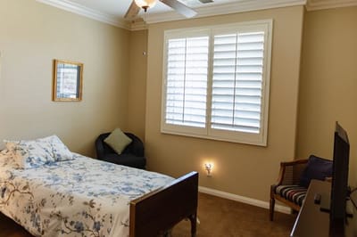 Cozy resident room with bed and chair