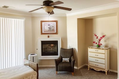 Cozy resident room with a chair and fireplace