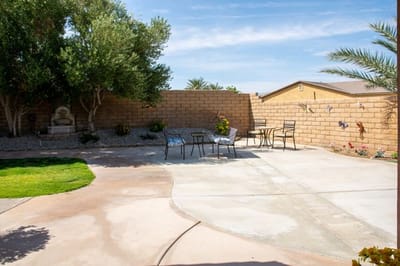 Outdoor patio area with seating and plants.