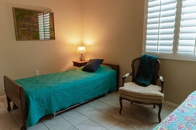 Cozy resident room with a bed and chair