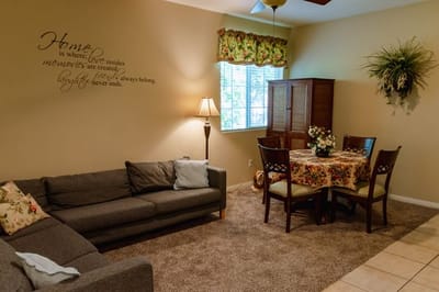 Cozy common area with a sofa and dining table.