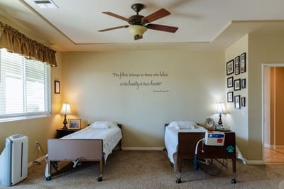 Cozy bedroom with two beds and wall quote