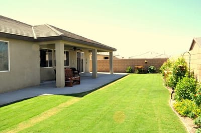 Well-maintained backyard lawn with seating