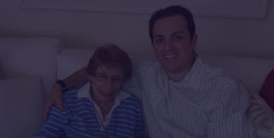 Senior resident with family member smiling together