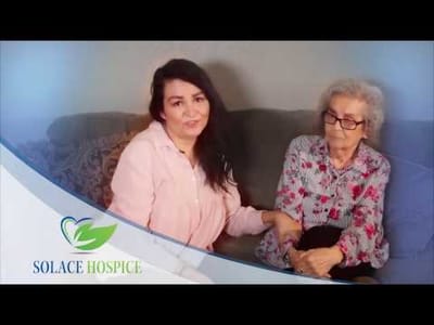 Caregiver with resident in cozy interior setting.