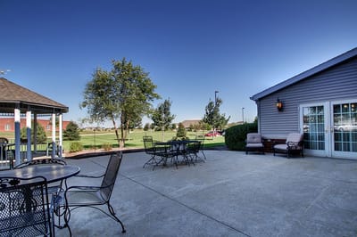 Outdoor patio area with seating and greenery