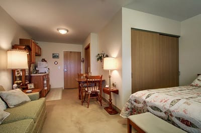 Cozy private room with a kitchenette and seating area.