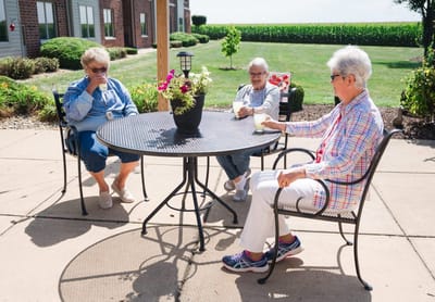 Three residents enjoying a sunny day outside.
