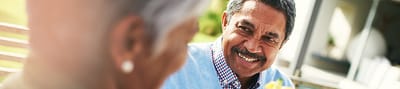 Smiling elderly man interacting with others