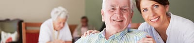 Resident smiling with caregiver in a common area