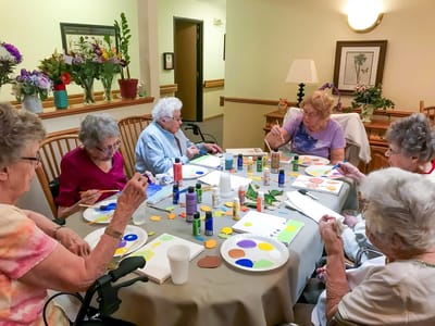 Residents engaged in a painting activity.