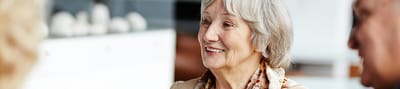 Senior woman smiling during a conversation