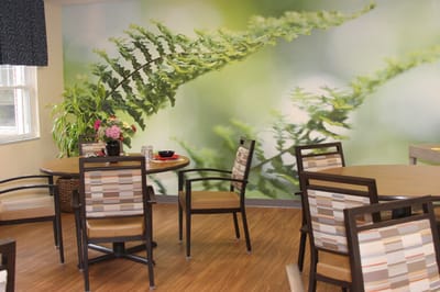 Dining area with modern decor and floral mural