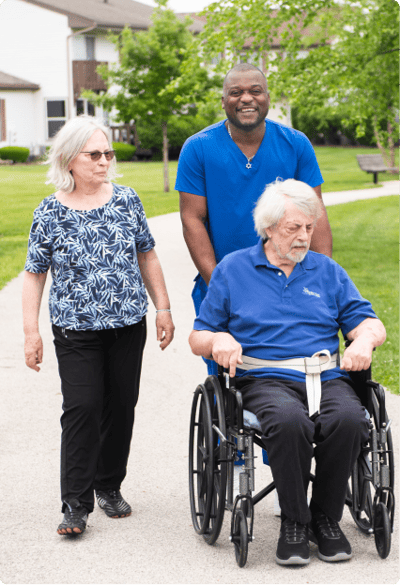 Care staff assisting residents outdoors