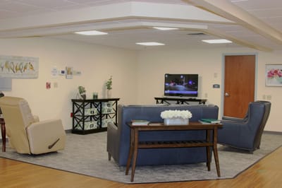 Cozy common area with furniture and TV.