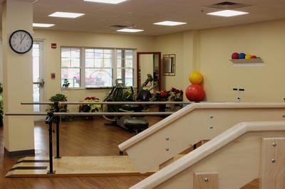 Rehabilitation gym with equipment and therapy stairs