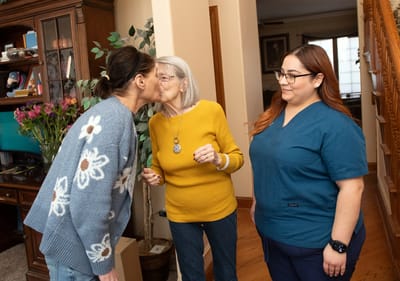 Care staff interacting warmly with a resident.