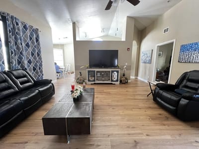 Cozy common area with black couches and decor.