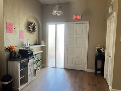 Welcoming entrance area with decor and floral arrangements.