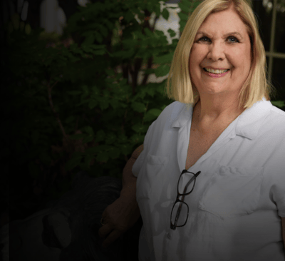 Smiling woman in a care facility setting.