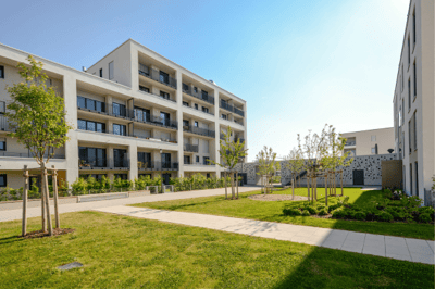 Modern outdoor space with greenery and buildings.
