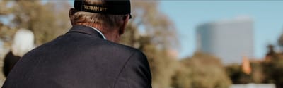 Senior veteran enjoying a reflective moment outdoors.