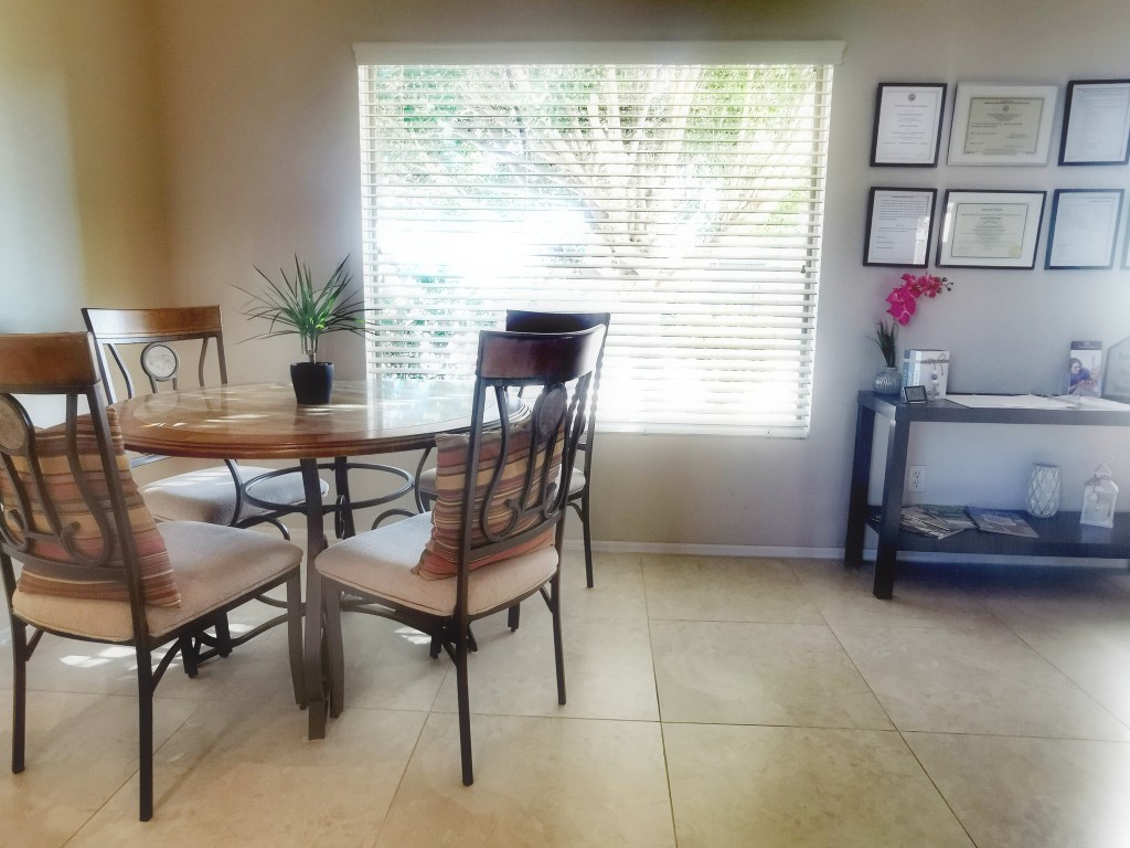 Bright common area with a dining table and chairs