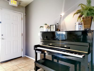 Piano in a well-lit corner of the facility interior