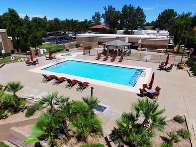 Outdoor pool area with lounge chairs and umbrellas