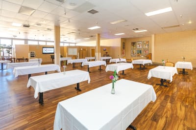 Bright activity room with tables set for an event