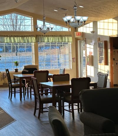 Light-filled common area with tables and chairs
