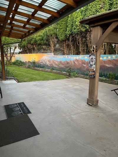 Outdoor space with a mural and grass area