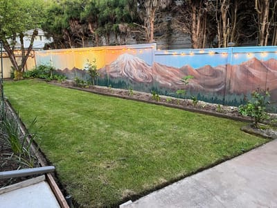 Well-maintained garden with a mural backdrop